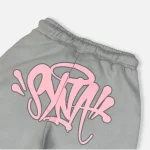Discover the Syna world Tracksuit Syna Logo Grey/Pink at Syna Worlds. We’ve created this unique design using high-quality materials.